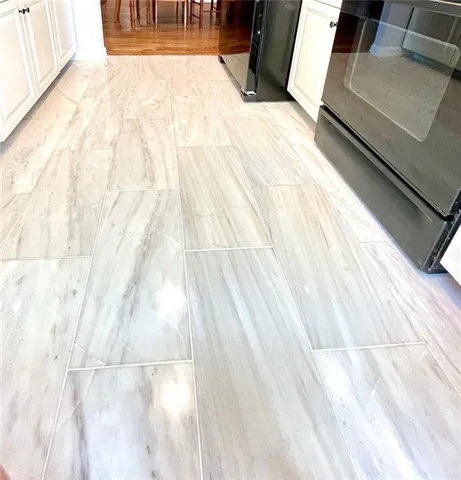 a stove top oven sitting inside of a kitchen