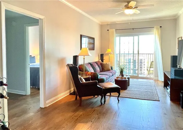 a view of a living room and floor to ceiling window and wooden floor