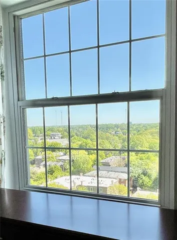 a bedroom with a bed and a lamp on dresser