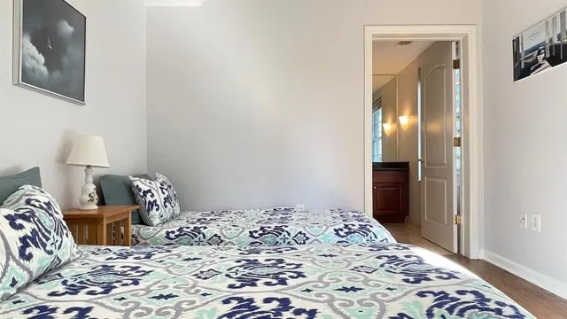 a bedroom with a bed and wooden floor