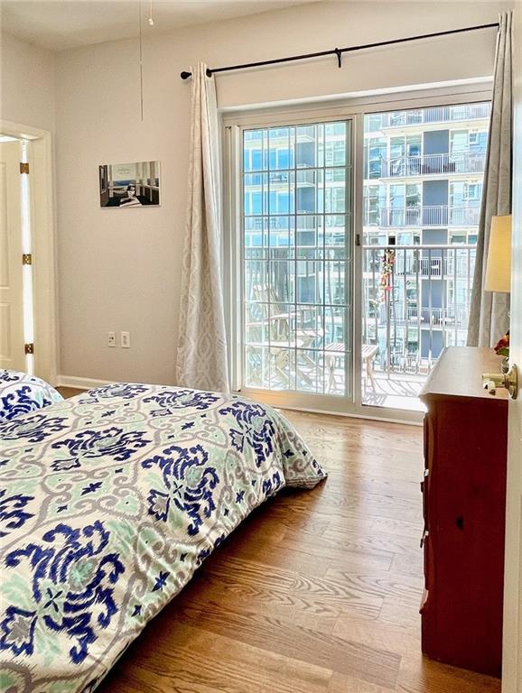 195 14th Street Northeast, Unit 1507 Atlanta, GA 30309 - Photo 30 of 56 a bedroom with a bed and wooden floor