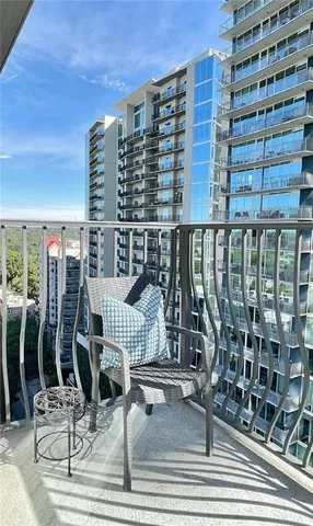 a view of a bedroom with wooden floor and windows