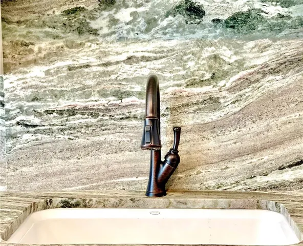 a close view of a sink and cabinets