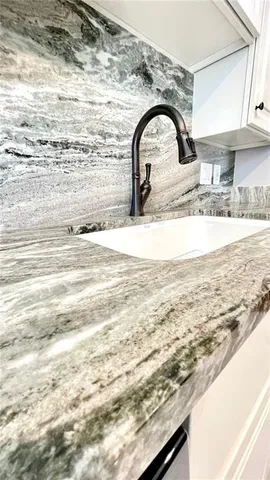 a kitchen with granite countertop a sink and a window