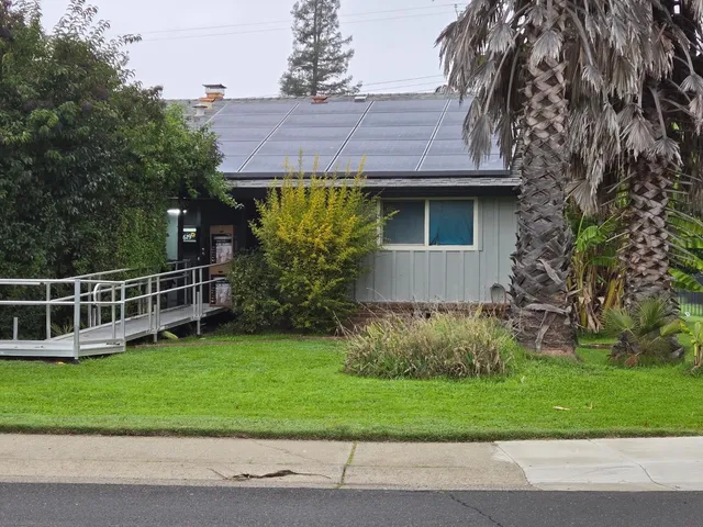 a view of a house with a yard and plants