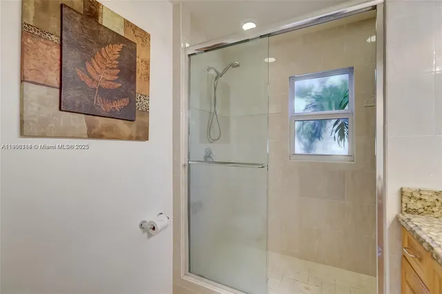 a bathroom with a shower and a bath tub