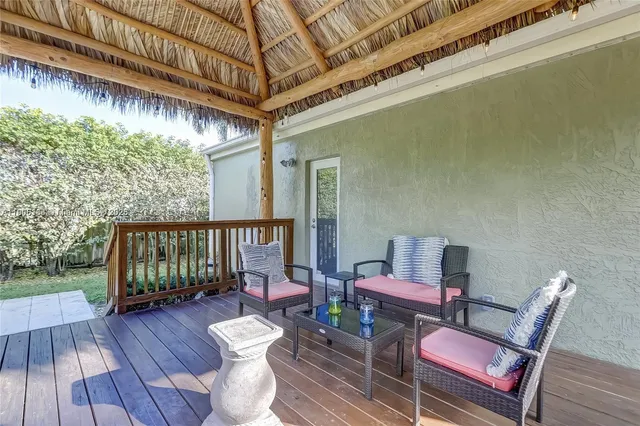 a view of a chairs and table under an umbrella