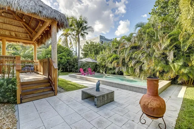 a view of a backyard with plants and a patio