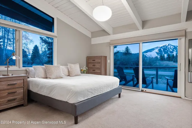 a bedroom with a large bed and a large window