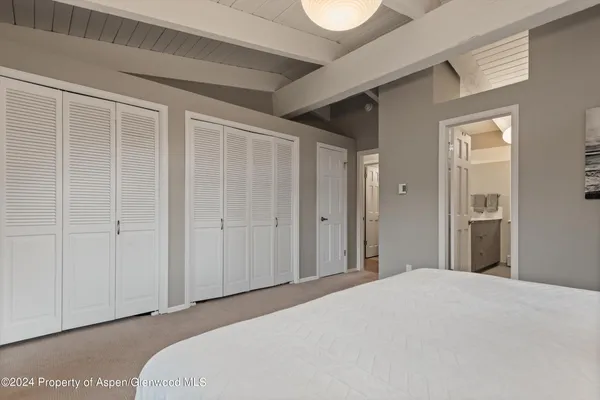 a bedroom with a bed and a cabinet