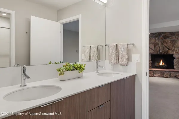 a bathroom with a double vanity sink and a mirror