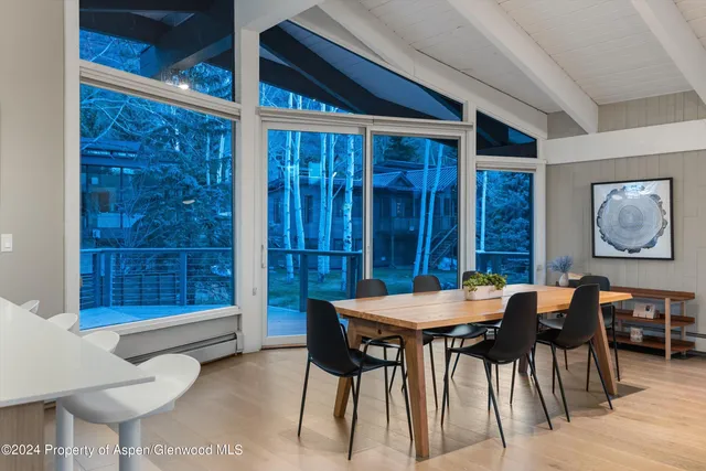 a view of a dining room with furniture and window