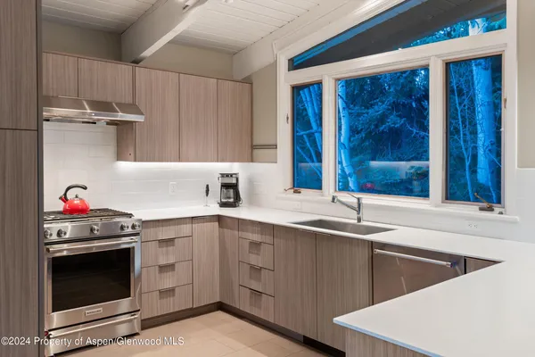 a kitchen with a sink stove and cabinets