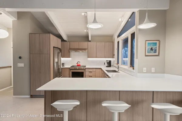 a kitchen with stainless steel appliances a sink and a refrigerator