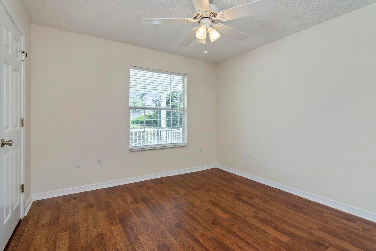 168 Cabana Way Crestview, FL 32536 - Photo 24 of 29 wooden floor in an empty room with a window