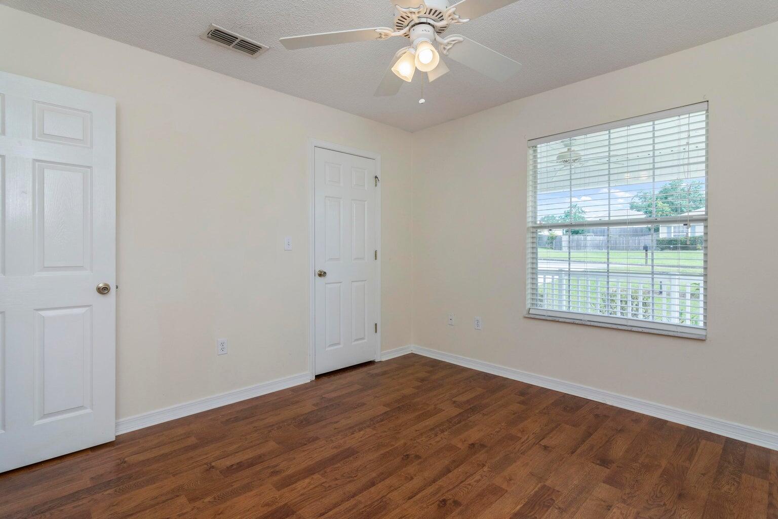 168 Cabana Way Crestview, FL 32536 - Photo 25 of 29 a view of an empty room with wooden floor and a window