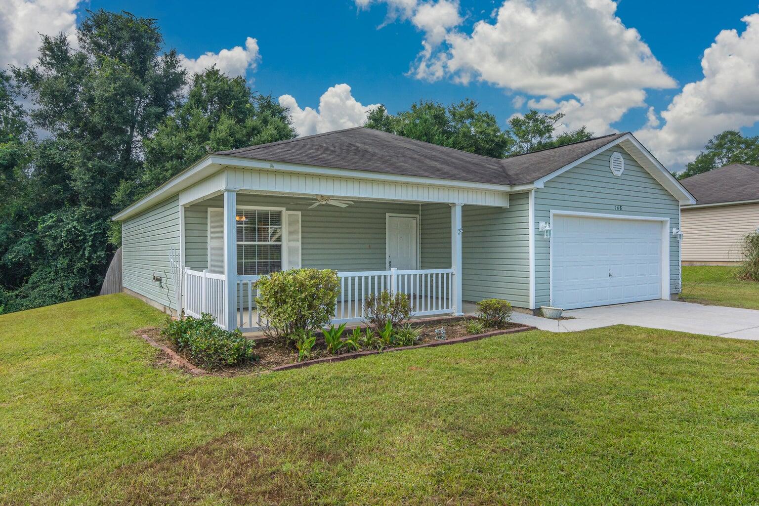 168 Cabana Way Crestview, FL 32536 - Photo 3 of 29 a front view of a house with a garden