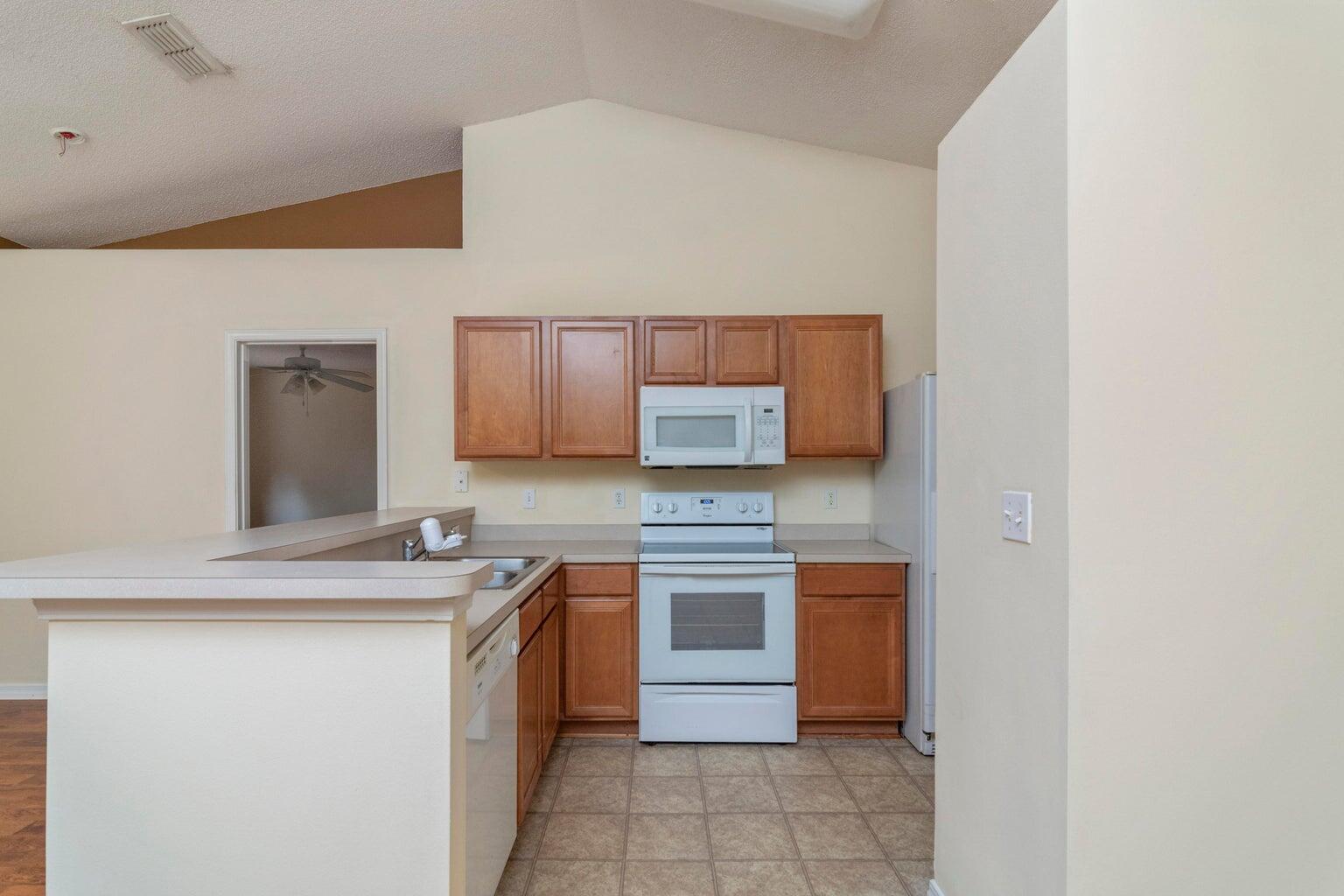 168 Cabana Way Crestview, FL 32536 - Photo 7 of 29 a kitchen with stainless steel appliances granite countertop a sink stove and cabinets