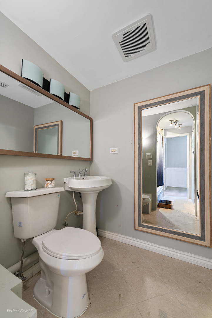 400 McCarthy Road, Unit 207 Lemont, IL 60439 - Photo 18 of 19 a bathroom with a toilet sink and mirror