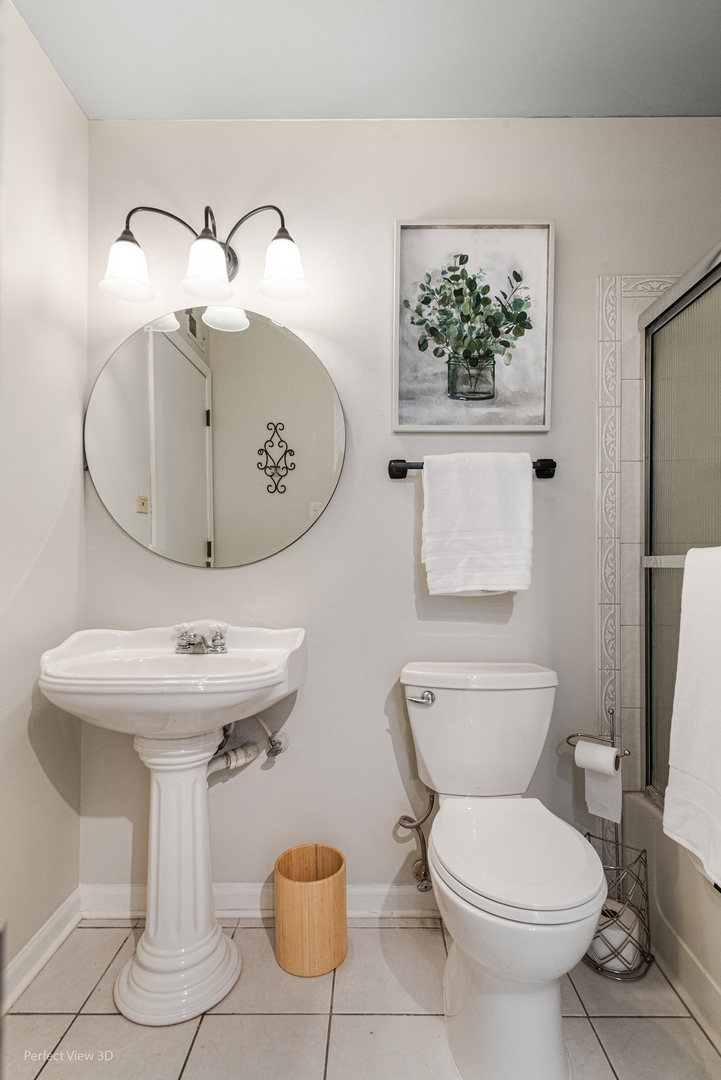 400 McCarthy Road, Unit 207 Lemont, IL 60439 - Photo 6 of 19 a bathroom with a toilet sink and mirror