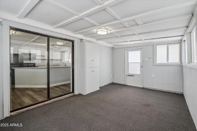 an empty room with sliding glass door