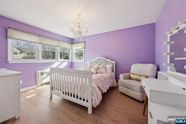 a bed room with a bed and a chair