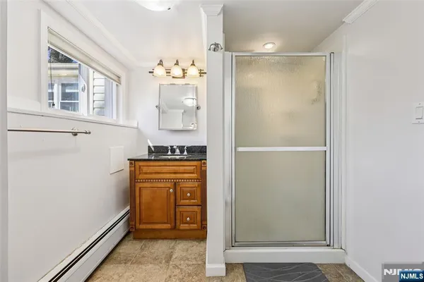 a bathroom with a shower and a sink