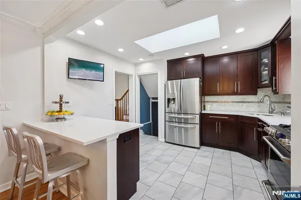 a kitchen with stainless steel appliances a refrigerator and a stove top oven