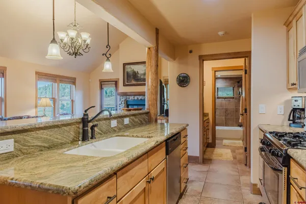 a bathroom with a granite countertop sink a large mirror and a window