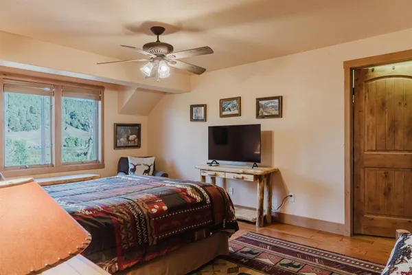 a bedroom with a bed and a flat screen tv