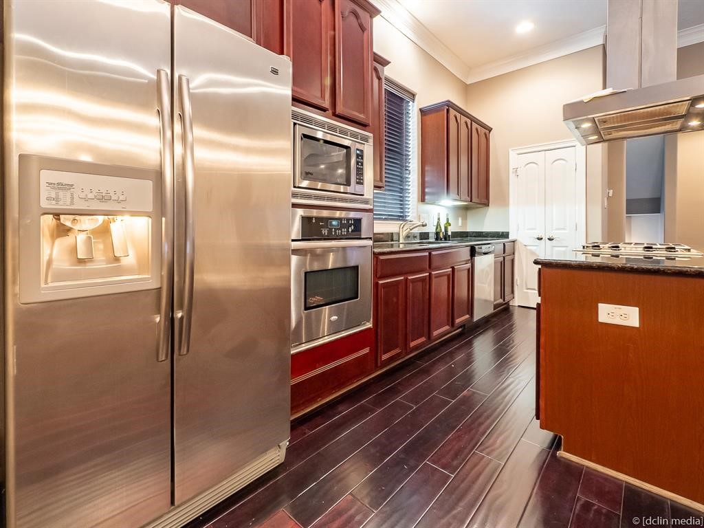 4118 Bonner View Lane Houston, TX 77007 - Photo 11 of 39 a kitchen with stainless steel appliances granite countertop a refrigerator a stove and a sink with wooden floor