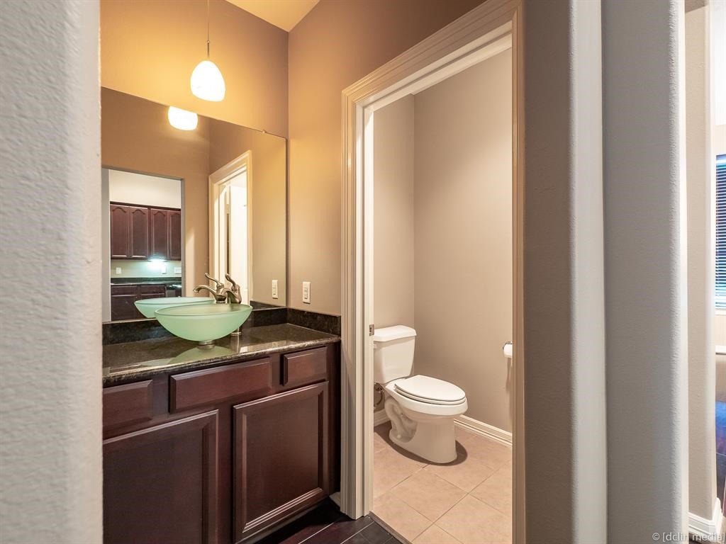 4118 Bonner View Lane Houston, TX 77007 - Photo 13 of 39 a bathroom with a granite countertop sink a toilet and a mirror