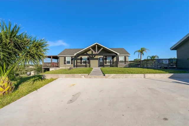 a view of house with outdoor space and swimming pool