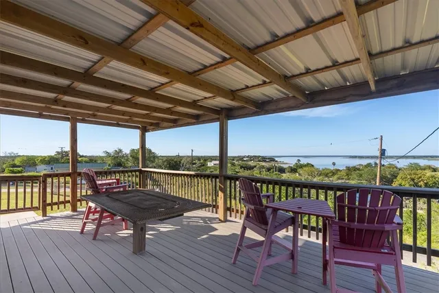 a roof deck with a table and chairs