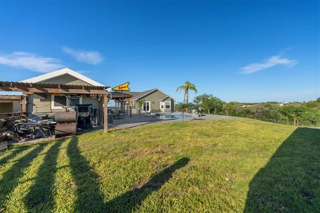 a view of a house with swimming pool and sitting area