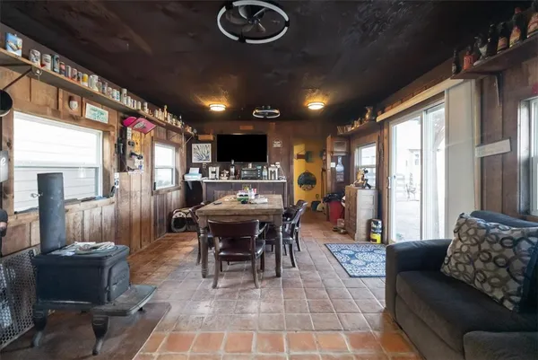 a dining room with furniture a rug a couch and a chandelier