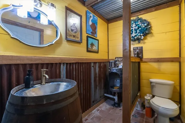 a bathroom with a sink a toilet and a mirror