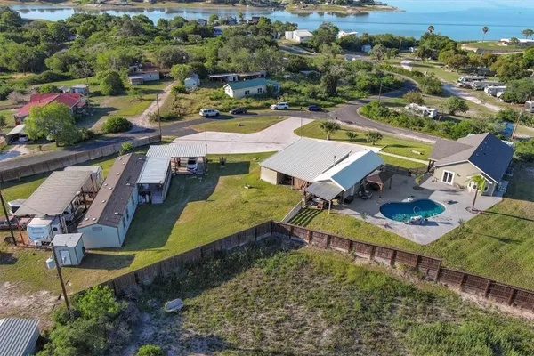 an aerial view of a house with a swimming pool yard and outdoor seating
