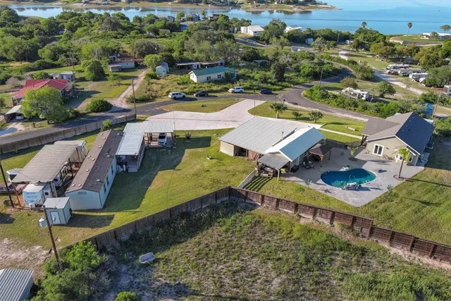 an aerial view of a house with a swimming pool yard and outdoor seating