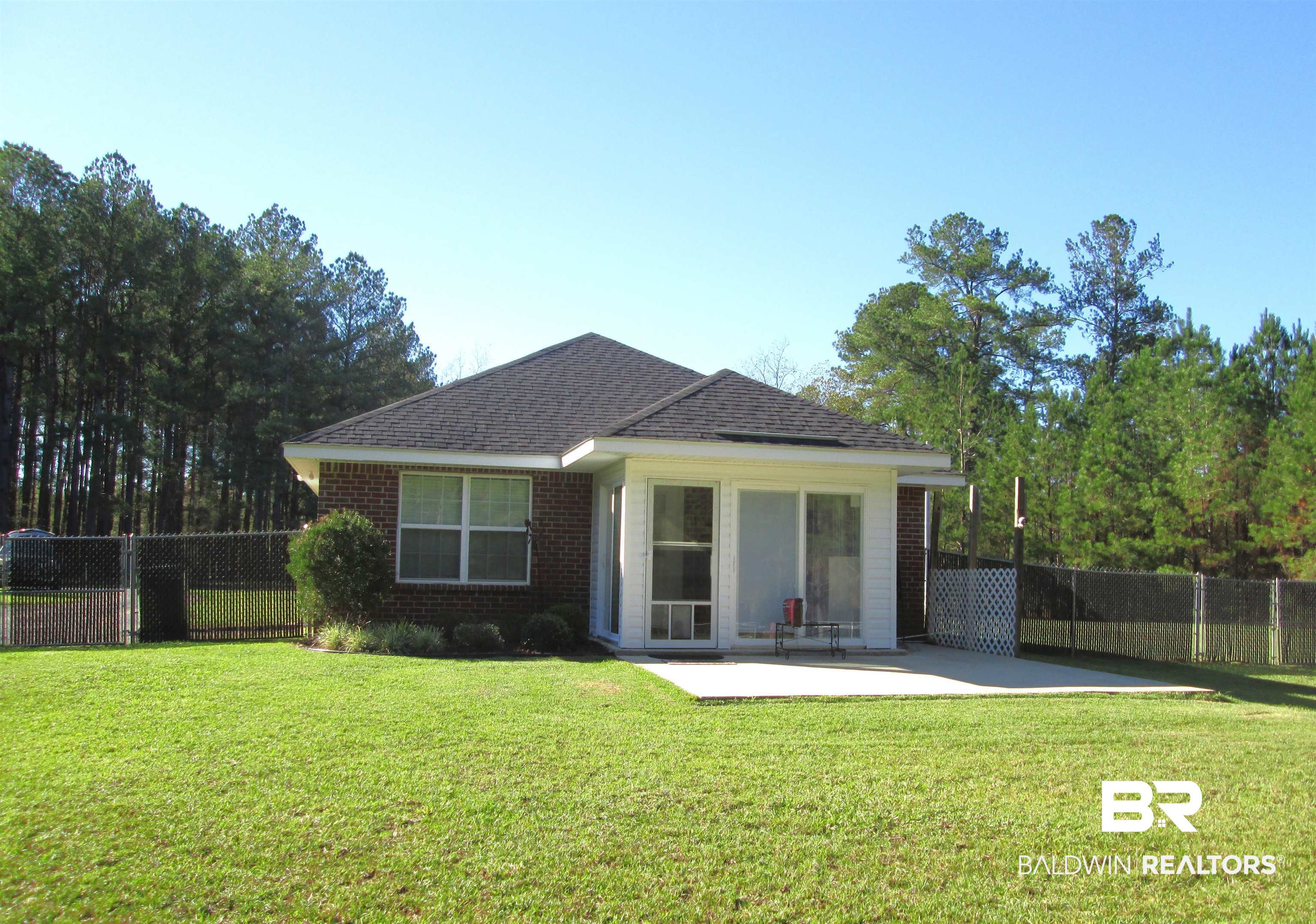 530 Brethren Church Road Fruitdale, AL 36539 - Photo 22 of 24 Back of property featuring a patio area and a lawn