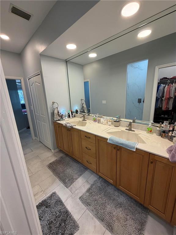 7791 Grande Pine Road Bokeelia, FL 33922 - Photo 25 of 45 a bathroom with a double vanity sink and a mirror
