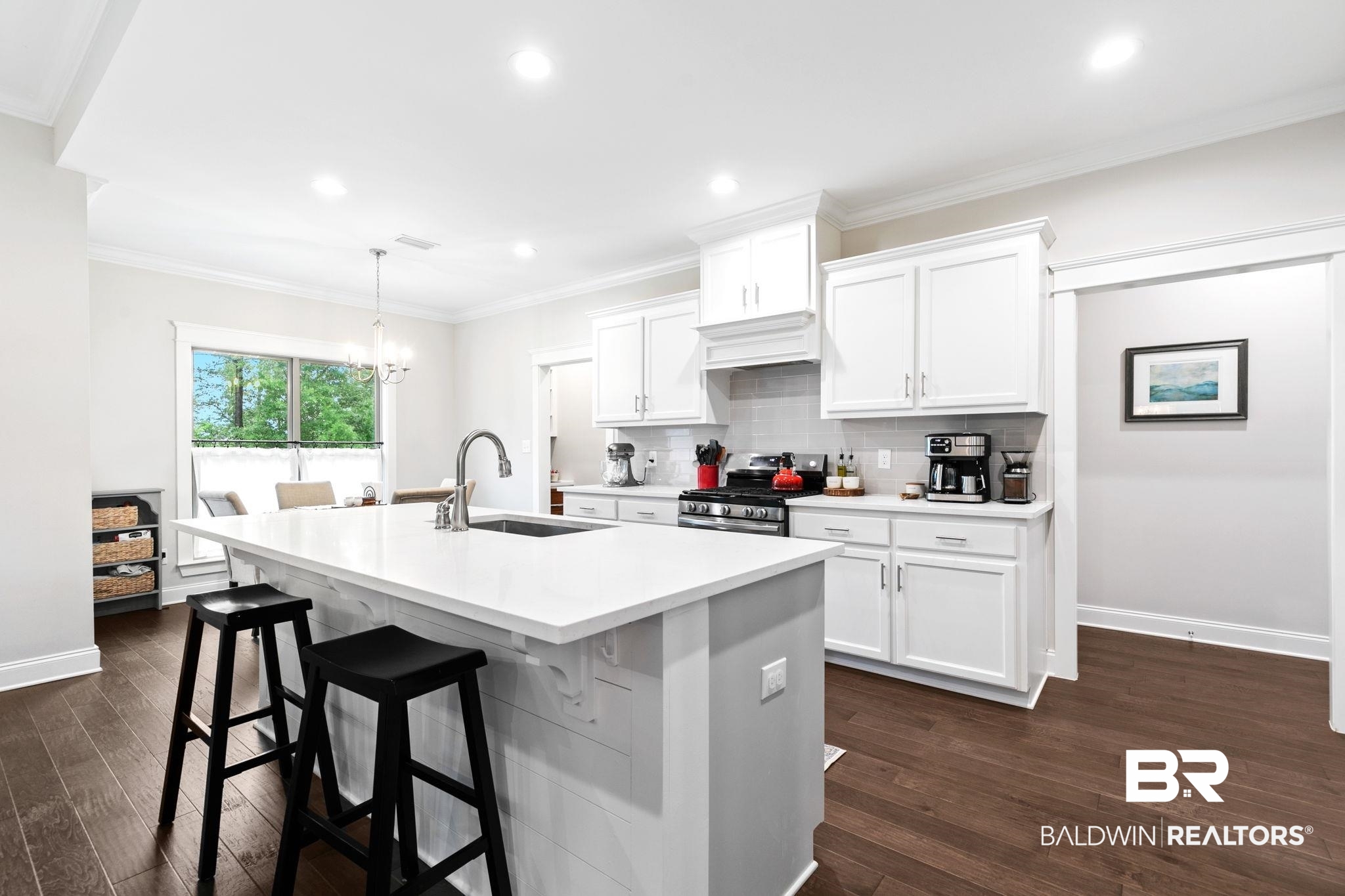 13233 Ibis Boulevard Daphne, AL 36527 - Photo 12 of 100 Bright kitchen featuring a central island with an undermount sink and gooseneck faucet