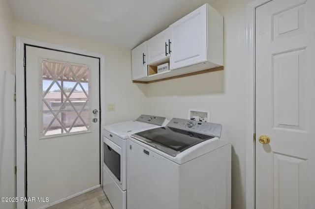 a kitchen with cabinets appliances and a wooden floor