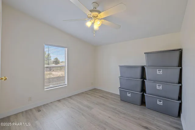 a view of room with cabinet and wooden floor