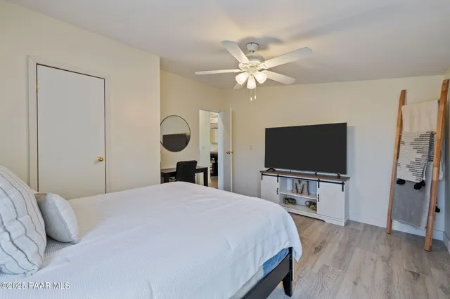 a bedroom with a bed and a flat screen tv