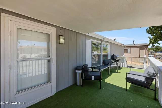 a backyard of a house with outdoor seating