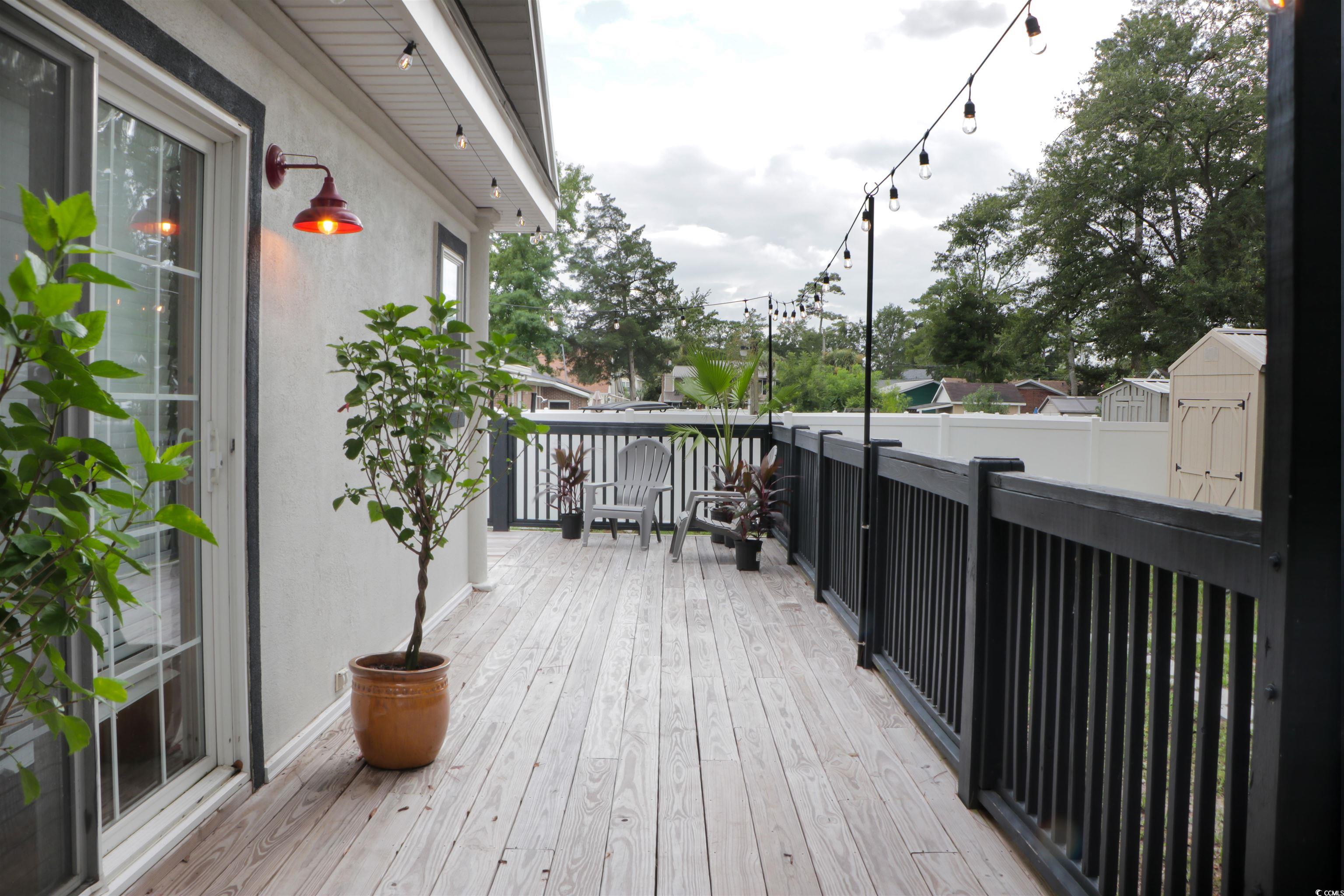 1014 Bay Drive Surfside Beach, SC 29575 - Photo 24 of 27 Wooden terrace featuring a storage unit