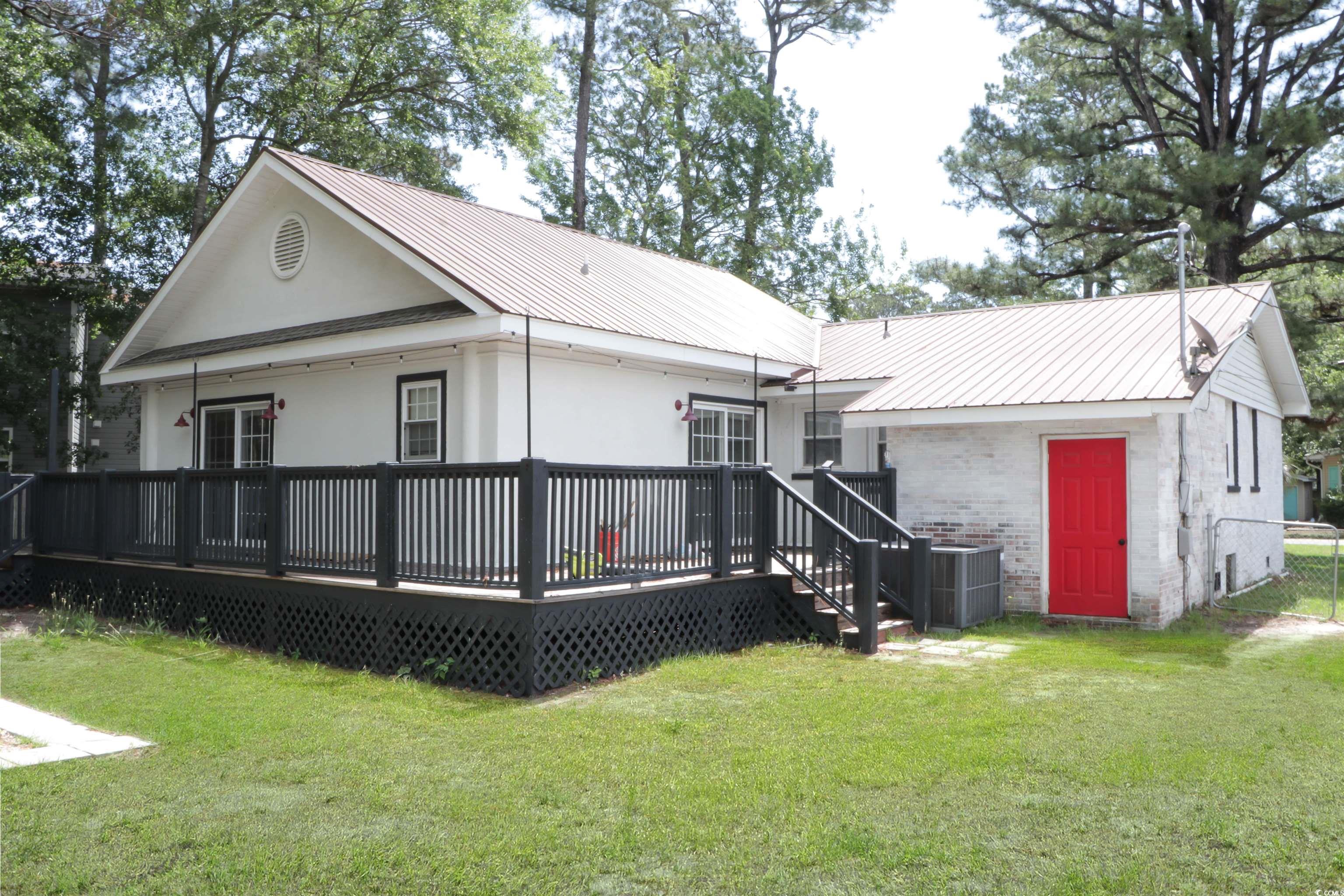 1014 Bay Drive Surfside Beach, SC 29575 - Photo 25 of 27 Back of property featuring a yard, central AC unit, metal roof, and a deck