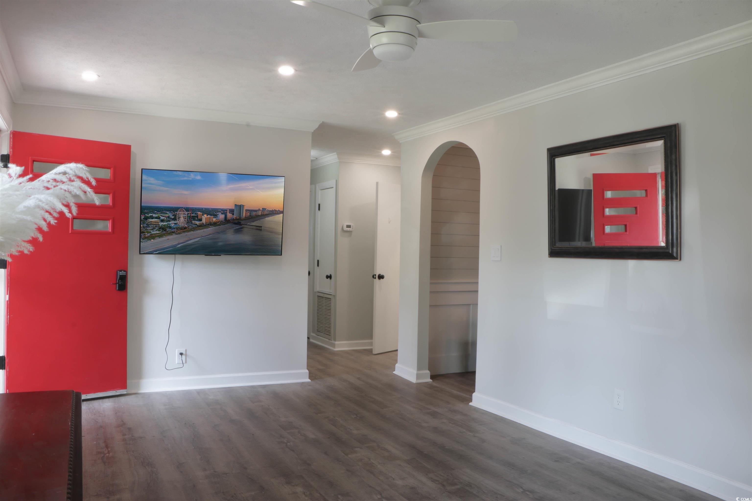 1014 Bay Drive Surfside Beach, SC 29575 - Photo 4 of 27 Unfurnished living room featuring wood finished floors, a ceiling fan, baseboards, recessed lighting, and arched walkways
