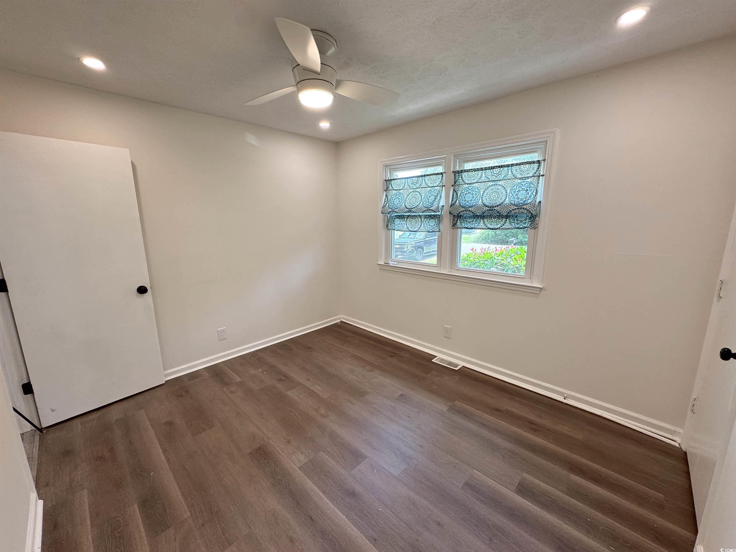 1014 Bay Drive Surfside Beach, SC 29575 - Photo 8 of 27 Unfurnished room featuring a ceiling fan, recessed lighting, baseboards, and dark wood-type flooring
